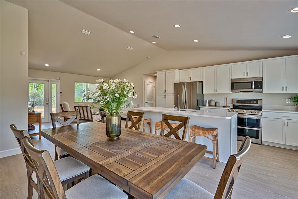 256 Portland Street Hawthorne, FL 32640 - Photo 18 of 35 a kitchen with stainless steel appliances a dining table chairs and granite counter tops