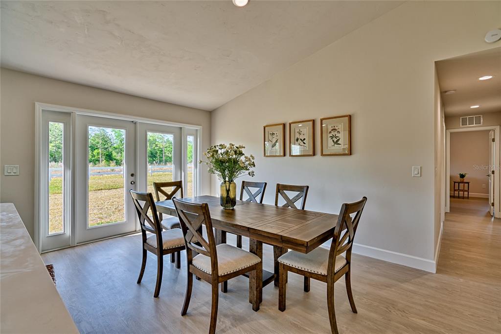 256 Portland Street Hawthorne, FL 32640 - Photo 19 of 35 a view of a dining room with furniture and wooden floor