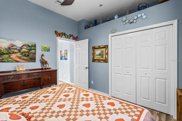 a bathroom with a granite countertop sink a toilet and a window