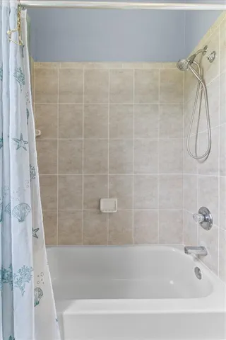 a view of a room with gym equipment and a large window