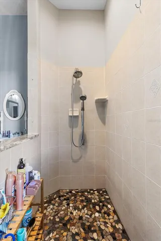 a room with a granite countertop sink and a mirror
