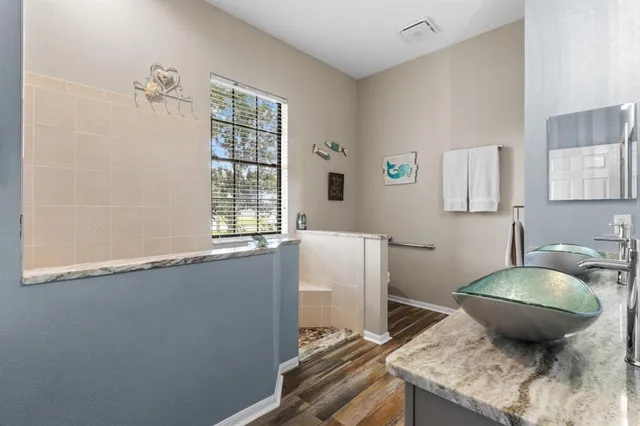 a spacious bedroom with a bed couch and a window