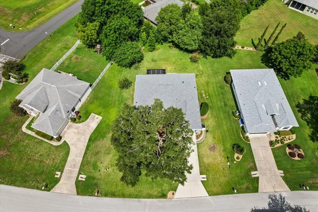 an aerial view of residential houses with outdoor space and street view