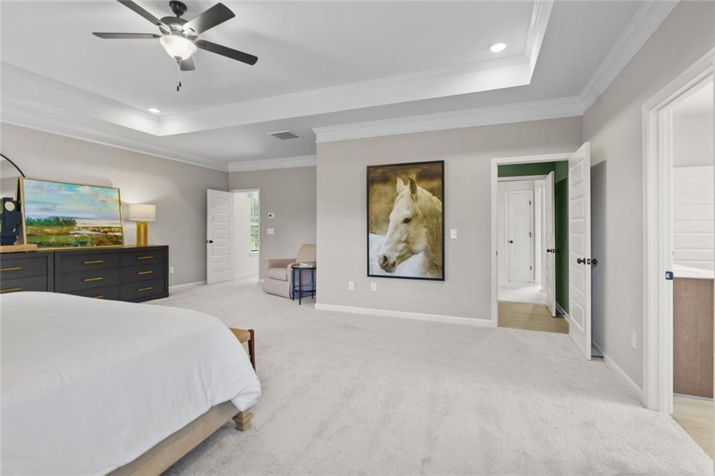 156 Saddle Ridge Trail Jasper, GA 30143 - Photo 30 of 45 a spacious bedroom with a bed and a chandelier