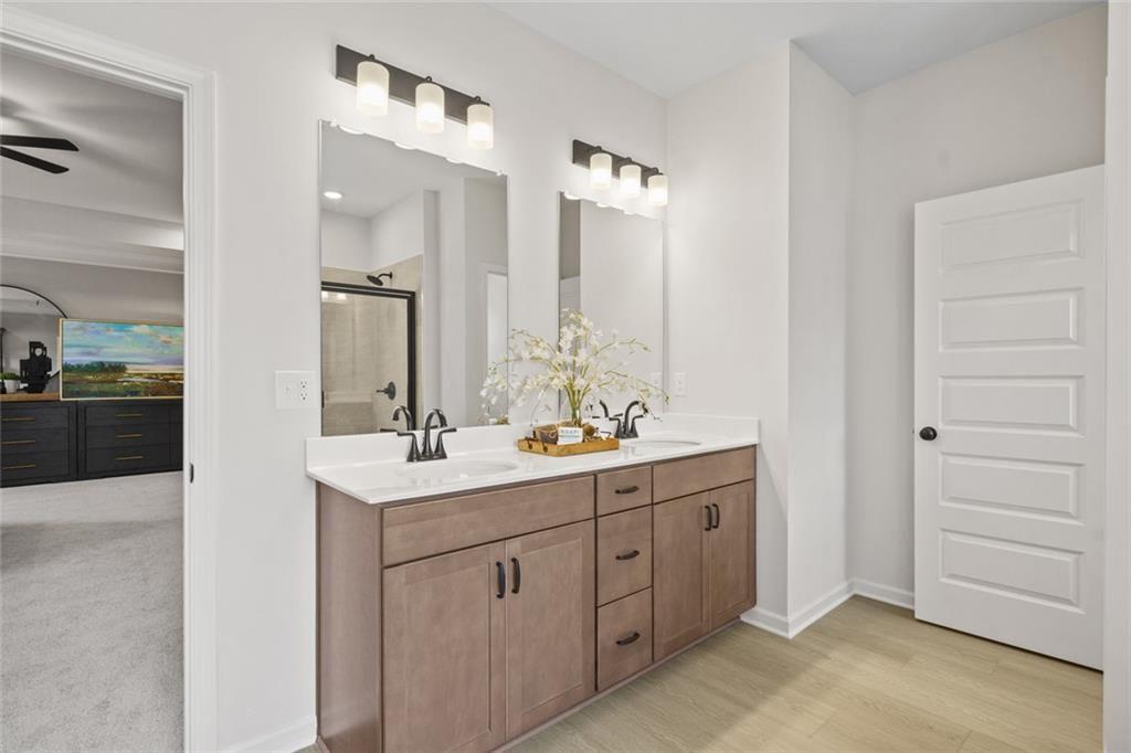 156 Saddle Ridge Trail Jasper, GA 30143 - Photo 33 of 45 a bathroom with a double vanity sink a mirror and a shower