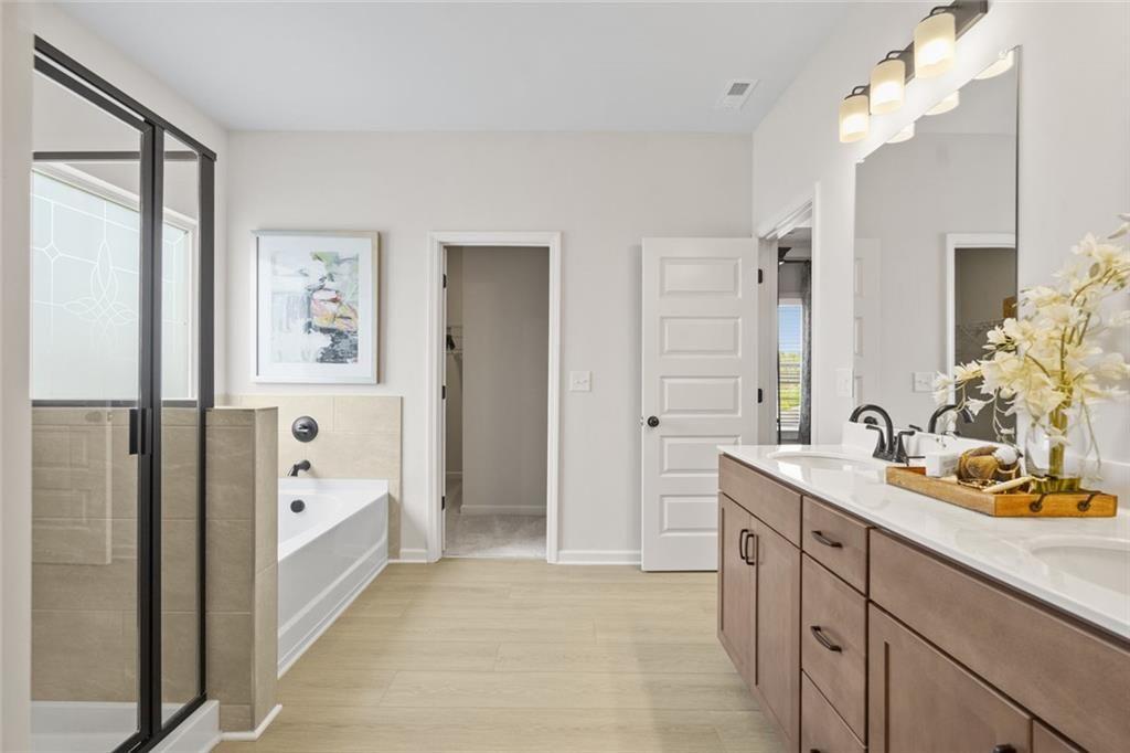 156 Saddle Ridge Trail Jasper, GA 30143 - Photo 35 of 45 a spacious bathroom with a double vanity sink a mirror and a bathtub