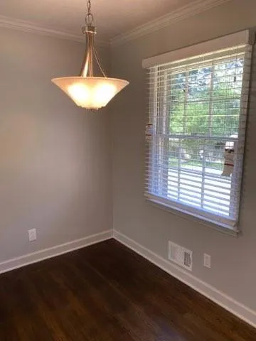 a room with wooden floor and a window