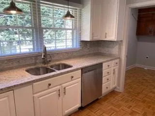 a kitchen with stainless steel appliances white cabinets and a sink