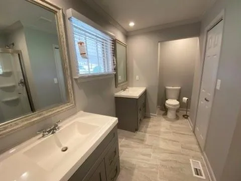 a bathroom with a sink a toilet and a mirror