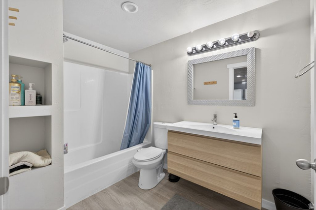 412 McClellan Court Provo, UT 84601 - Photo 16 of 20 Bathroom with vanity, light wood finished floors, and shower / bath combo with shower curtain