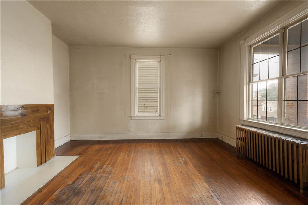 208 Linnview Avenue Pittsburgh, PA 15210 - Photo 16 of 26 wooden floor in an empty room with a window
