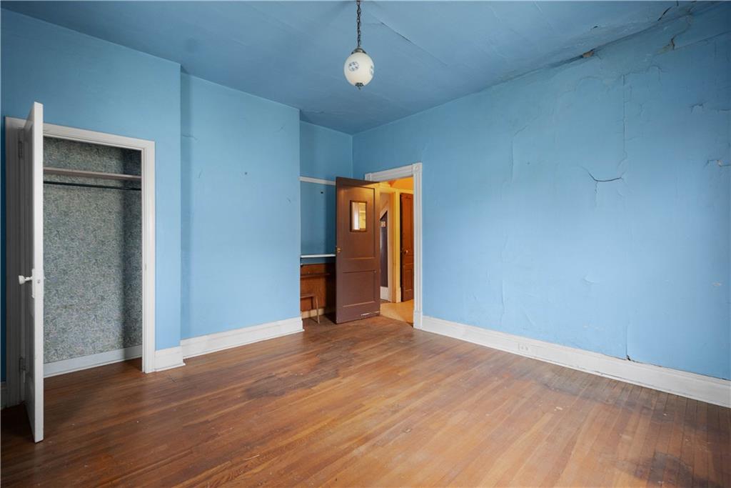 208 Linnview Avenue Pittsburgh, PA 15210 - Photo 17 of 26 an empty room with wooden floor closet and windows