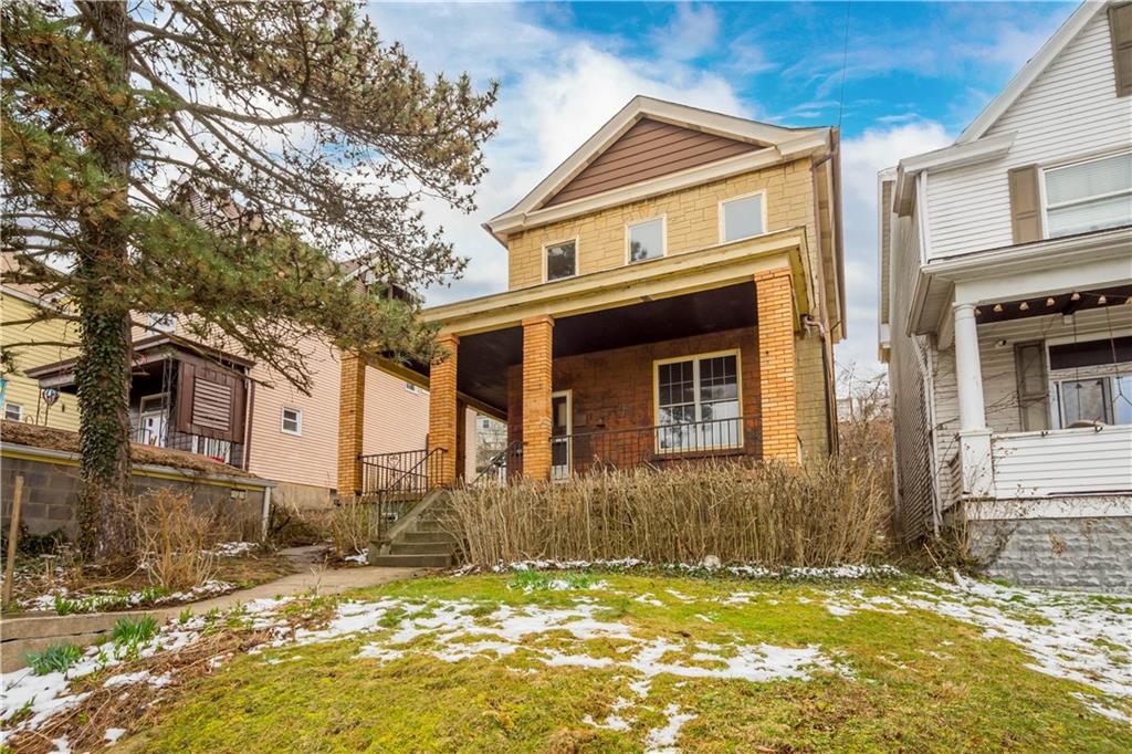 208 Linnview Avenue Pittsburgh, PA 15210 - Photo 2 of 26 a view of a brick house with a large windows
