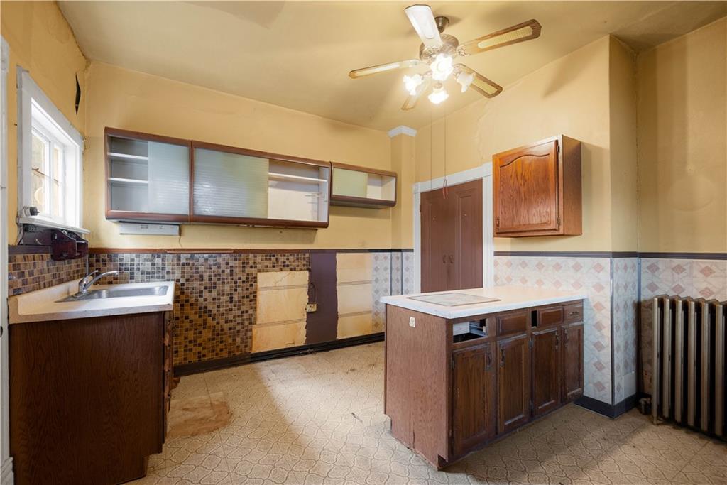 208 Linnview Avenue Pittsburgh, PA 15210 - Photo 21 of 26 a kitchen with stainless steel appliances granite countertop a sink stove and refrigerator