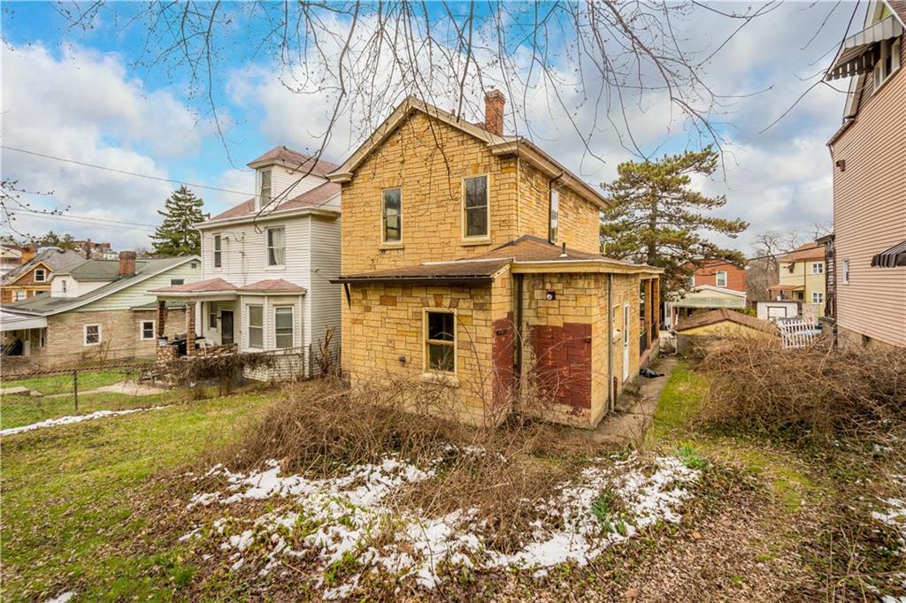 208 Linnview Avenue Pittsburgh, PA 15210 - Photo 4 of 26 a view of a big white house with a large windows next to a yard