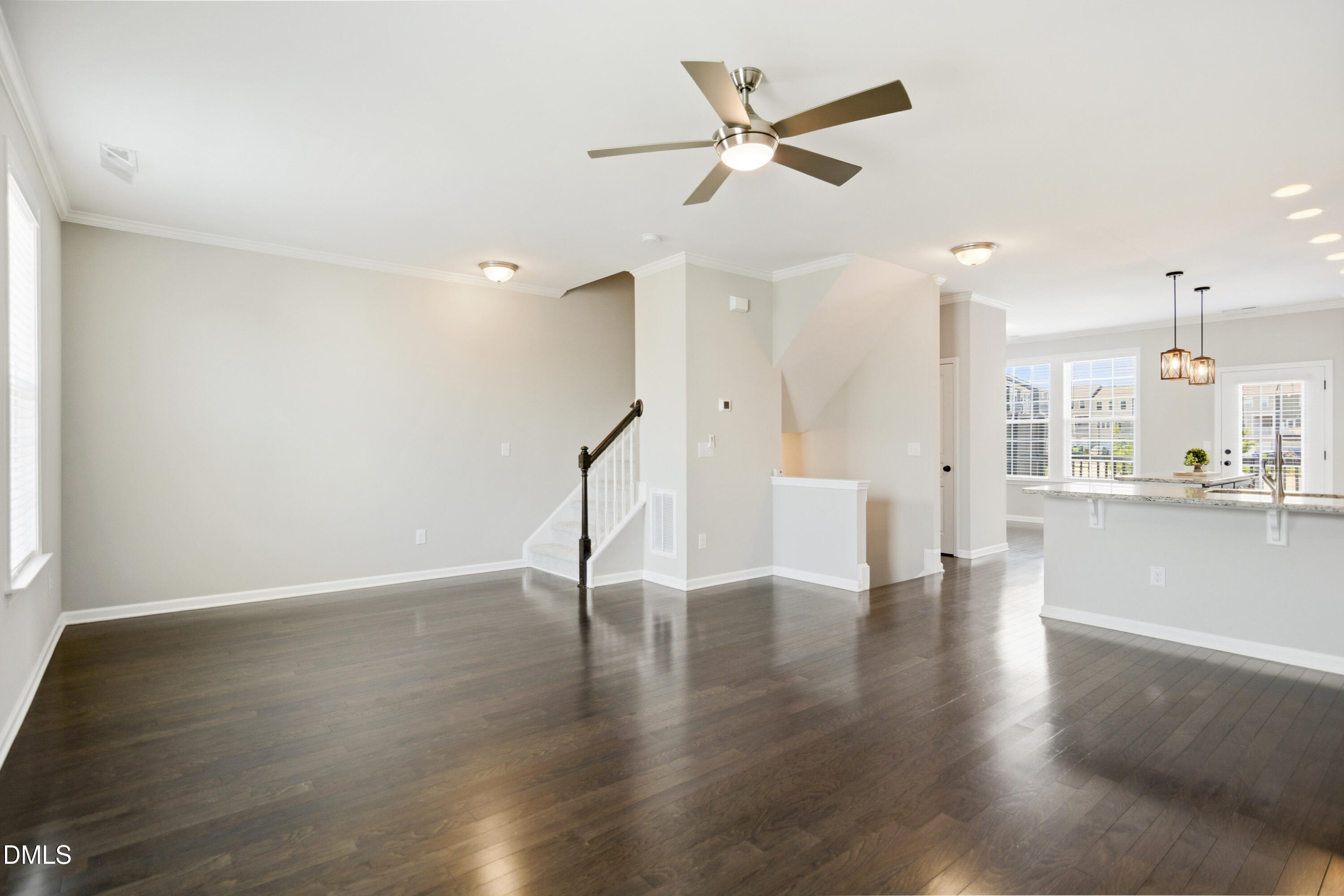 5916 Giddings Street Raleigh, NC 27616 - Photo 5 of 49 a view of an empty room with wooden floor and a ceiling fan