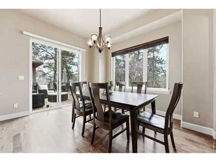 a view of a dining room with furniture wooden floor and chandelier