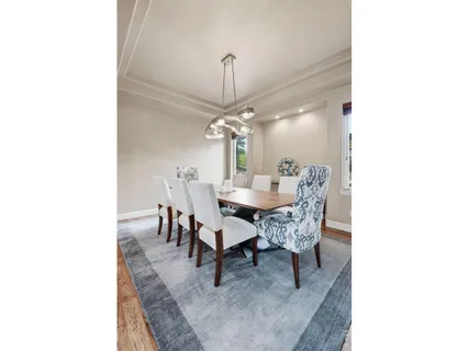 a dining room with a table and chairs