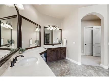 a bathroom with a sink a vanity a mirror and bathtub