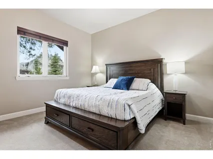 a bed sitting in a bedroom next to a window