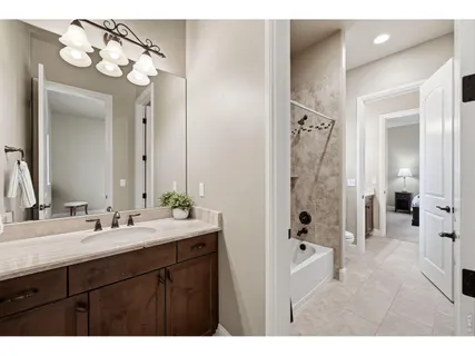 a bathroom with a double vanity sink mirror and shower