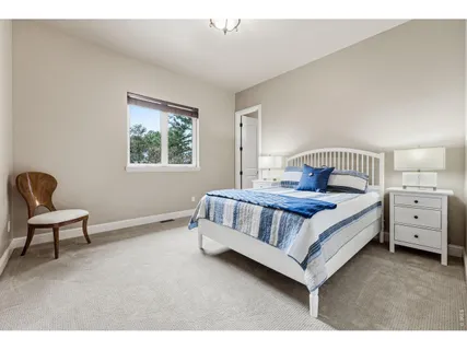 a bedroom with a bed and a chair