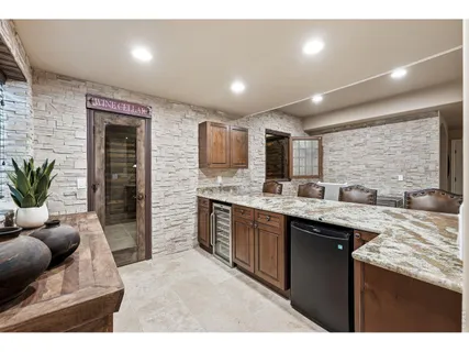 a kitchen with stainless steel appliances granite countertop sink stove refrigerator and cabinets