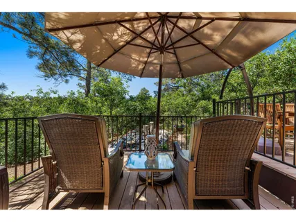 a view of balcony with wooden floor and outdoor seating