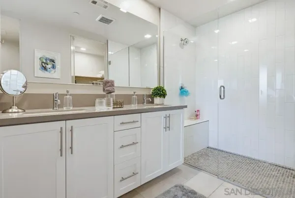 a kitchen with stainless steel appliances kitchen island granite countertop a stove a sink dishwasher and a refrigerator with wooden floor