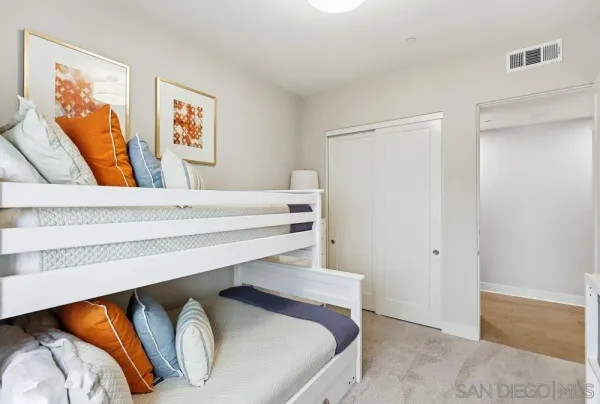 a bathroom with a double vanity sink a mirror and a bathtub