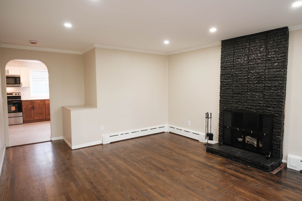 181 Freeman Terrace Springfield, MA 01104 - Photo 18 of 37 a view of empty room with wooden floor and fireplace
