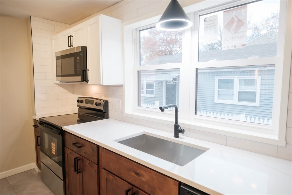 181 Freeman Terrace Springfield, MA 01104 - Photo 20 of 37 a kitchen with granite countertop a sink and a stove