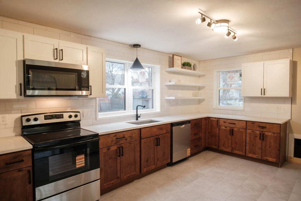181 Freeman Terrace Springfield, MA 01104 - Photo 22 of 37 a kitchen with a sink stove and microwave
