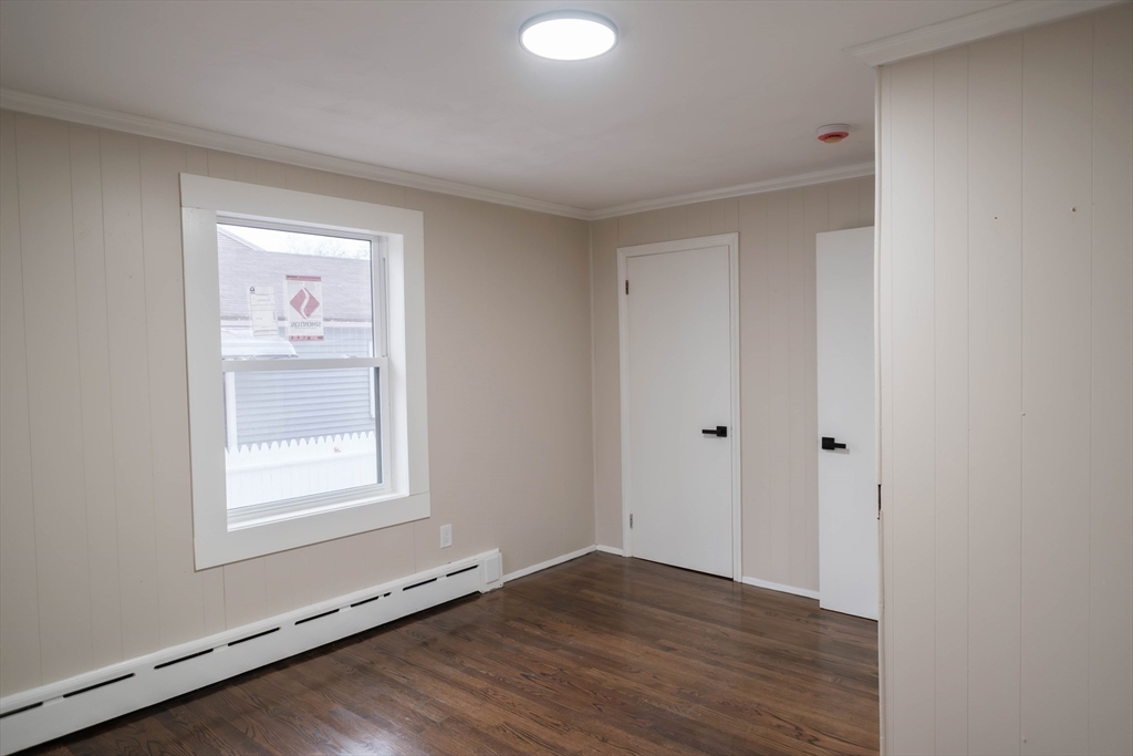 181 Freeman Terrace Springfield, MA 01104 - Photo 28 of 37 a view of an empty room with wooden floor and a window