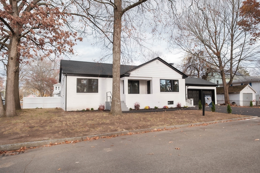 181 Freeman Terrace Springfield, MA 01104 - Photo 4 of 37 a white house that has a tree in front of it