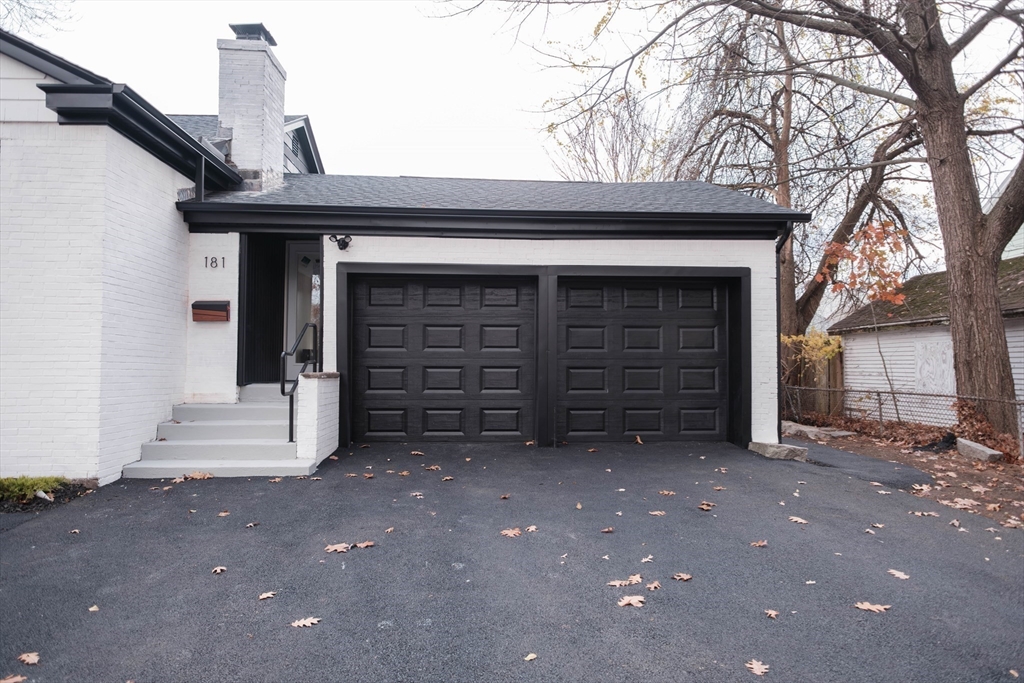 181 Freeman Terrace Springfield, MA 01104 - Photo 5 of 37 a front view of a house with a garage