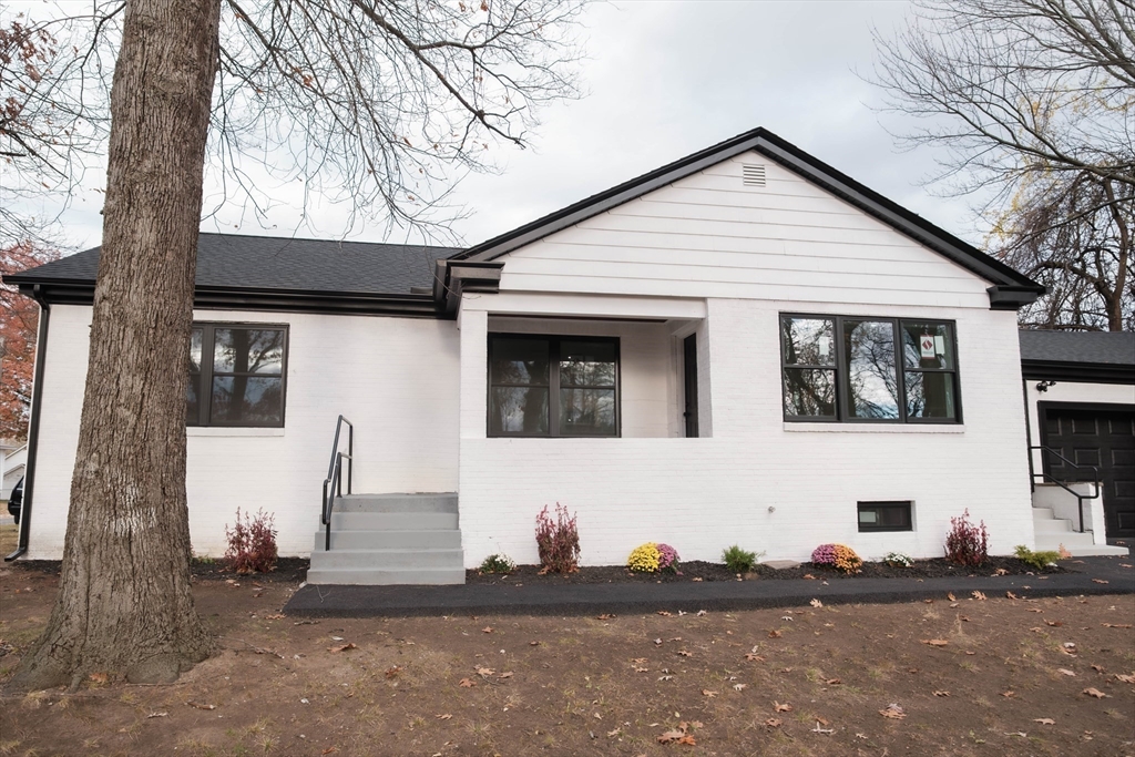 181 Freeman Terrace Springfield, MA 01104 - Photo 7 of 37 a front view of a house with a yard