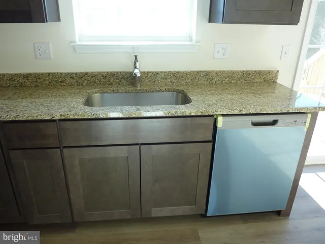 a kitchen with granite countertop a sink and a granite counter tops