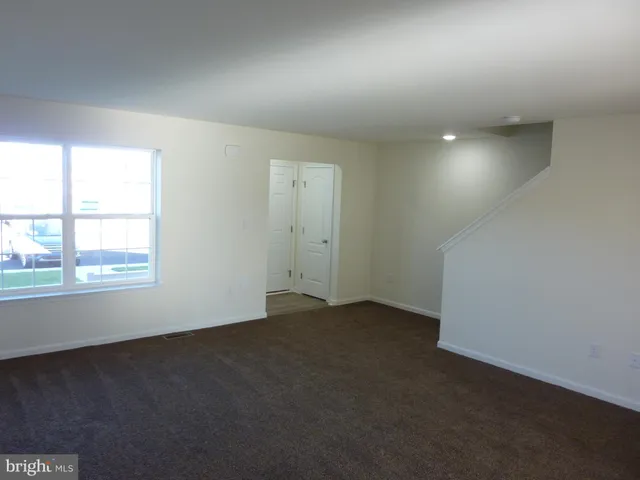 an empty room with a empty space and windows