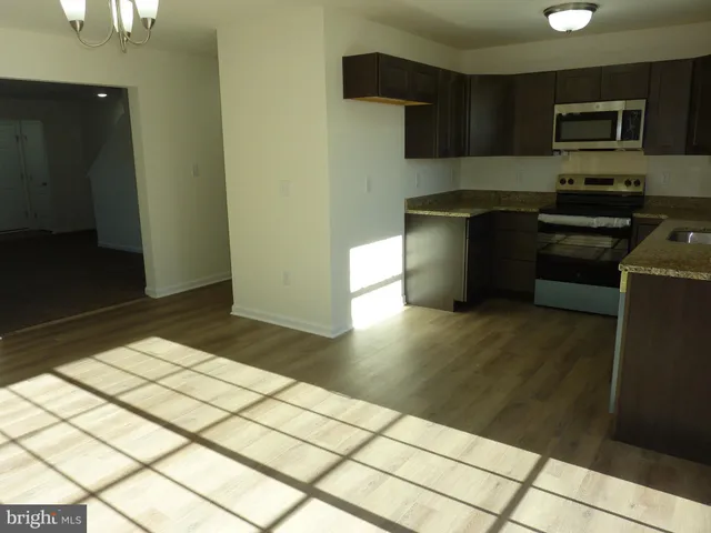 a kitchen with a sink a stove and refrigerator