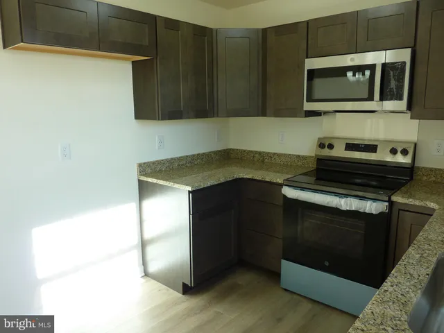 a kitchen with a stove and a microwave