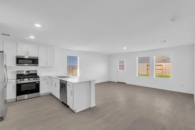 a kitchen with a stove and a refrigerator
