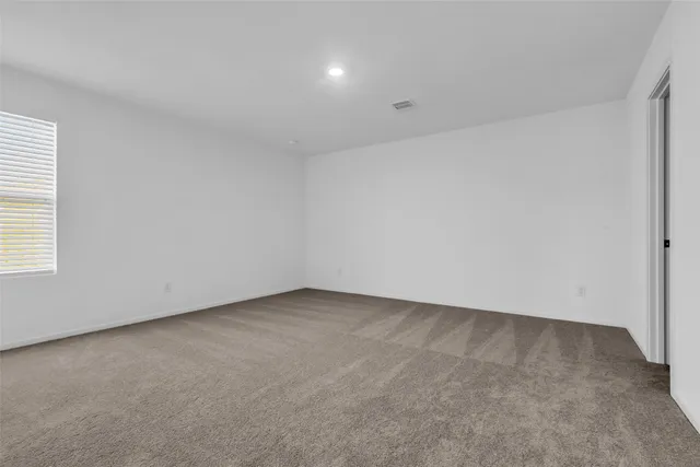 an empty room with a empty space and windows