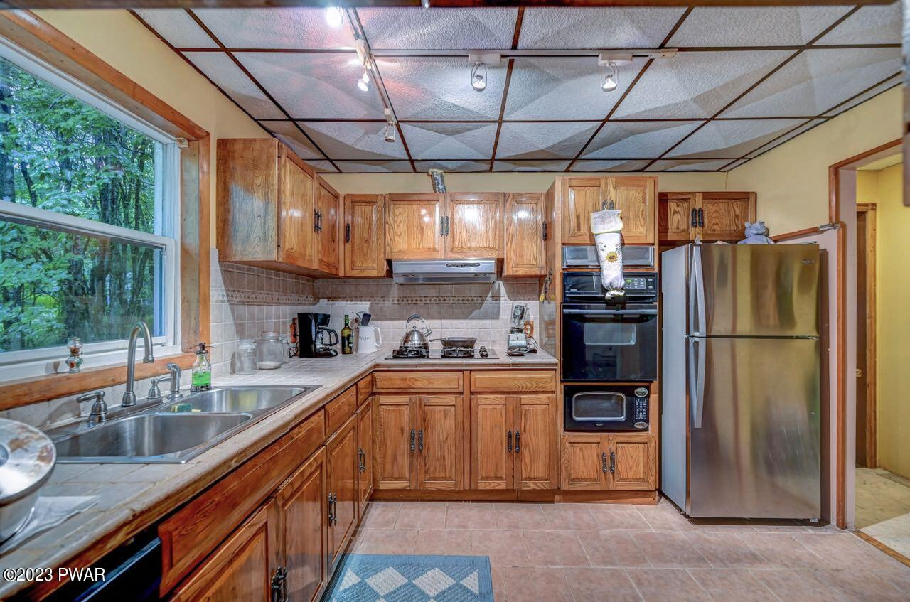 20 Wash Road Waymart, PA 18472 - Photo 11 of 49 a kitchen with stainless steel appliances granite countertop a sink window and refrigerator