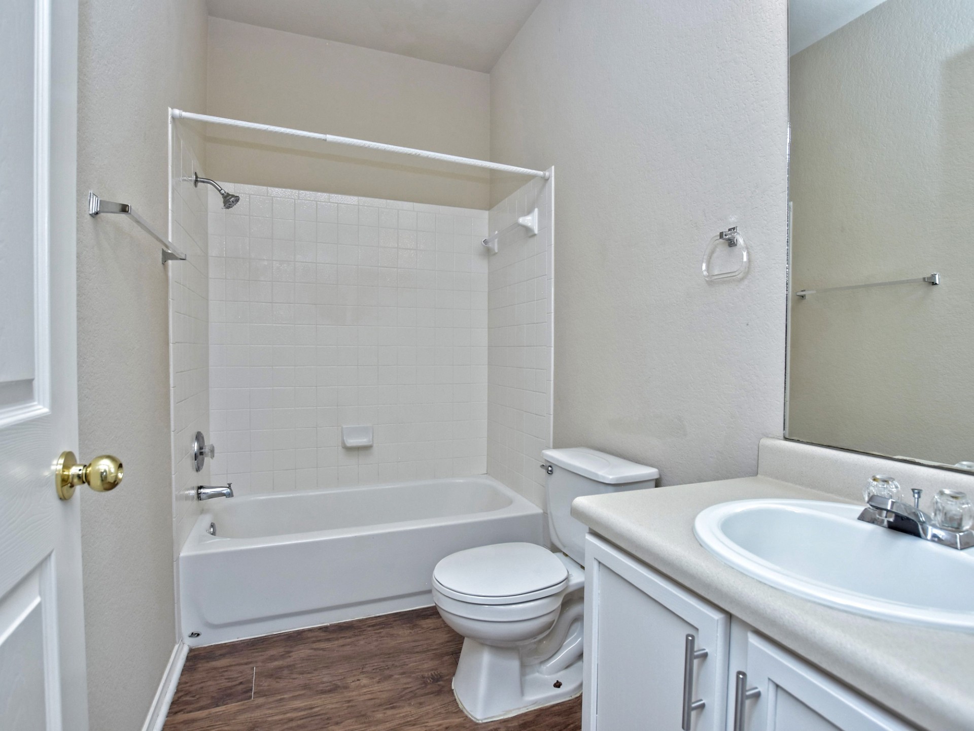 917 East 3rd Street Georgetown, TX 78626 - Photo 13 of 23 Functional full bathroom featuring a tub and shower combination with ample counter space and a vanity mirror.