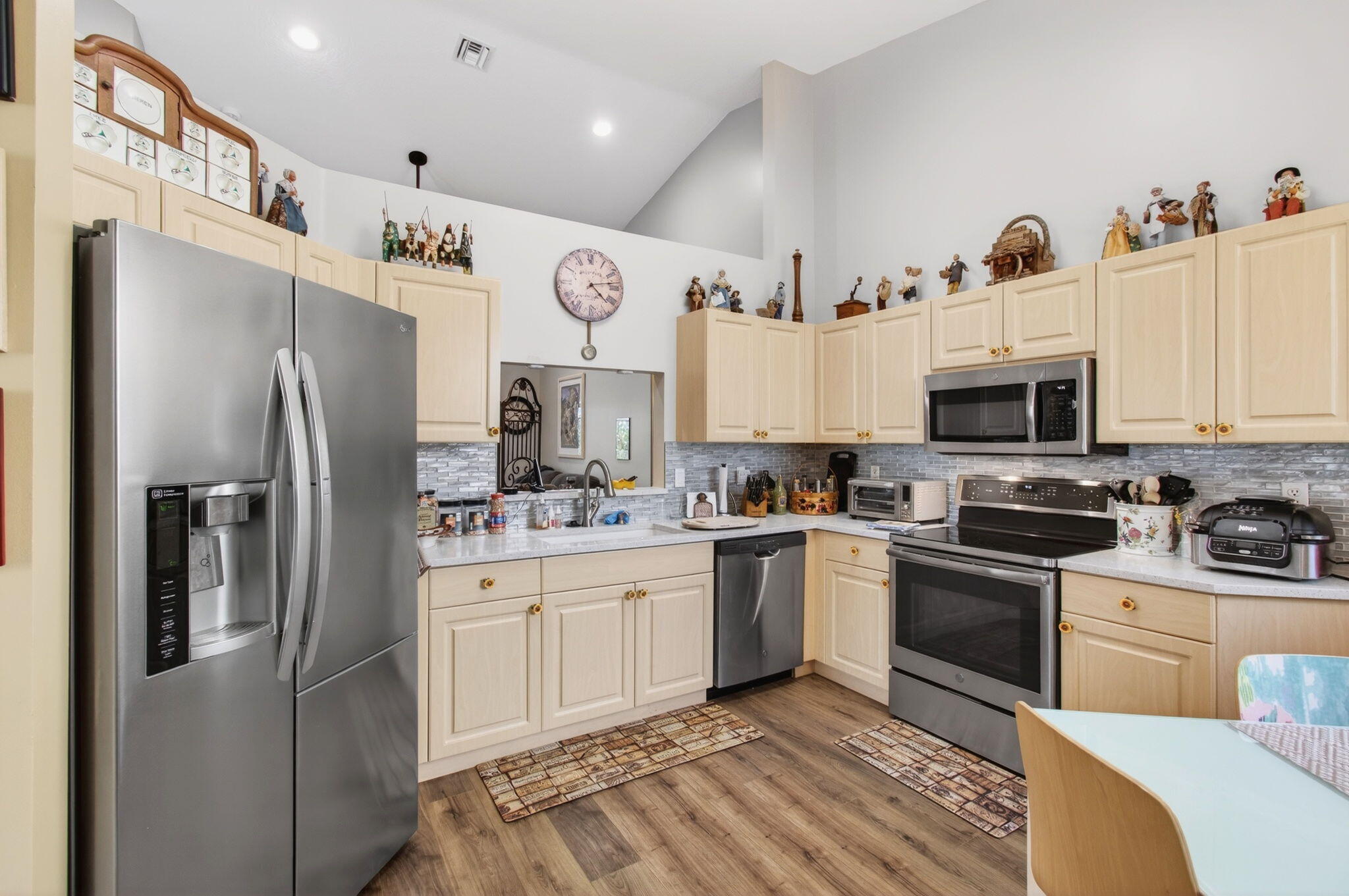 6253 Heliconia Road Delray Beach, FL 33484 - Photo 23 of 85 a kitchen with stainless steel appliances granite countertop a refrigerator sink and stove