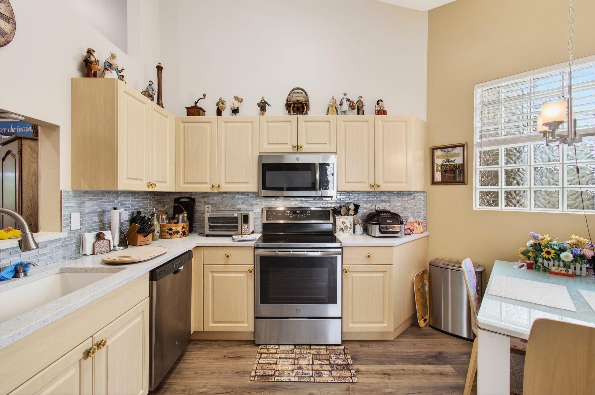 6253 Heliconia Road Delray Beach, FL 33484 - Photo 26 of 85 a kitchen with stainless steel appliances granite countertop a stove and a refrigerator