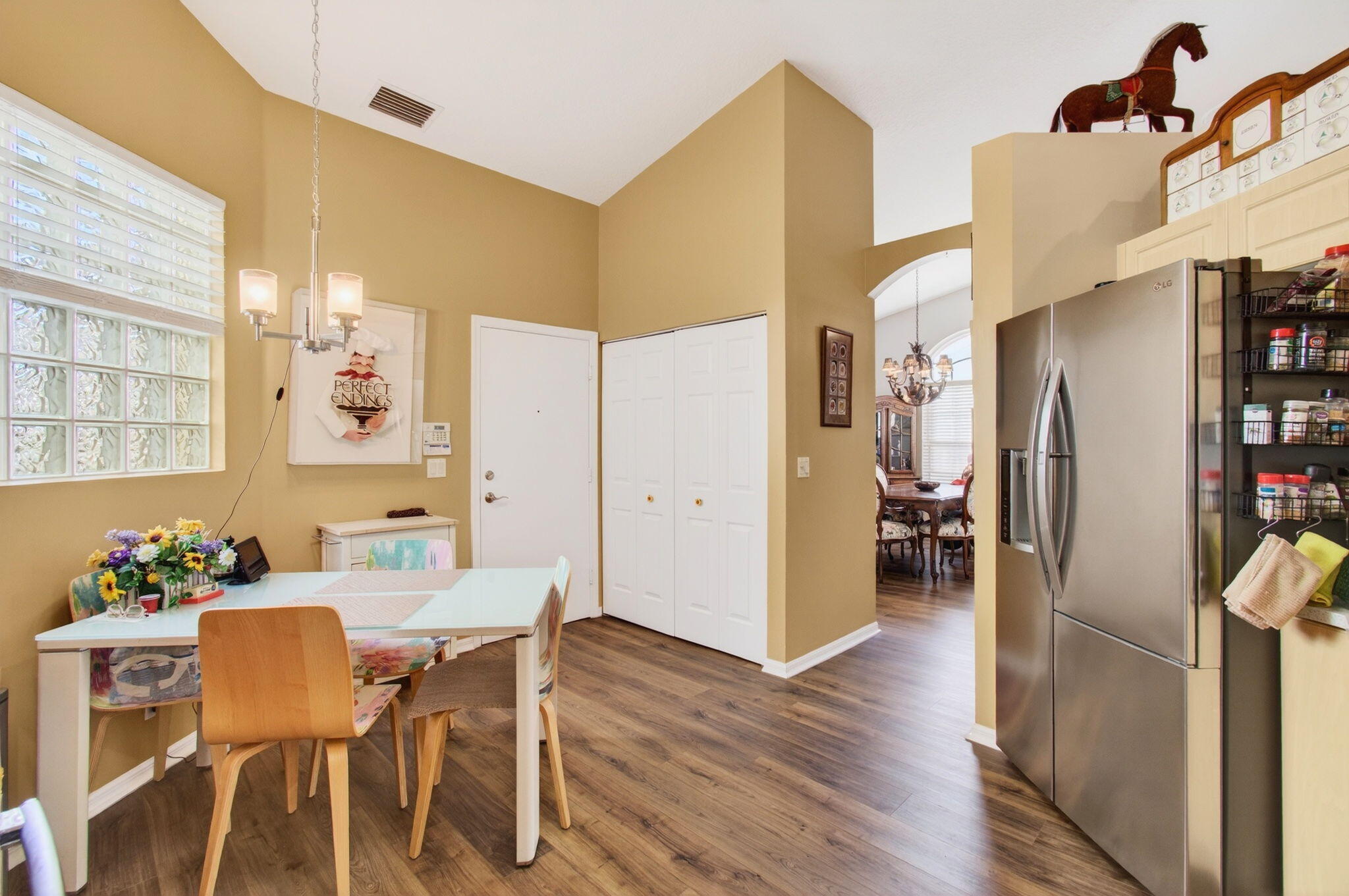 6253 Heliconia Road Delray Beach, FL 33484 - Photo 27 of 85 a view of a dining room with furniture and wooden floor