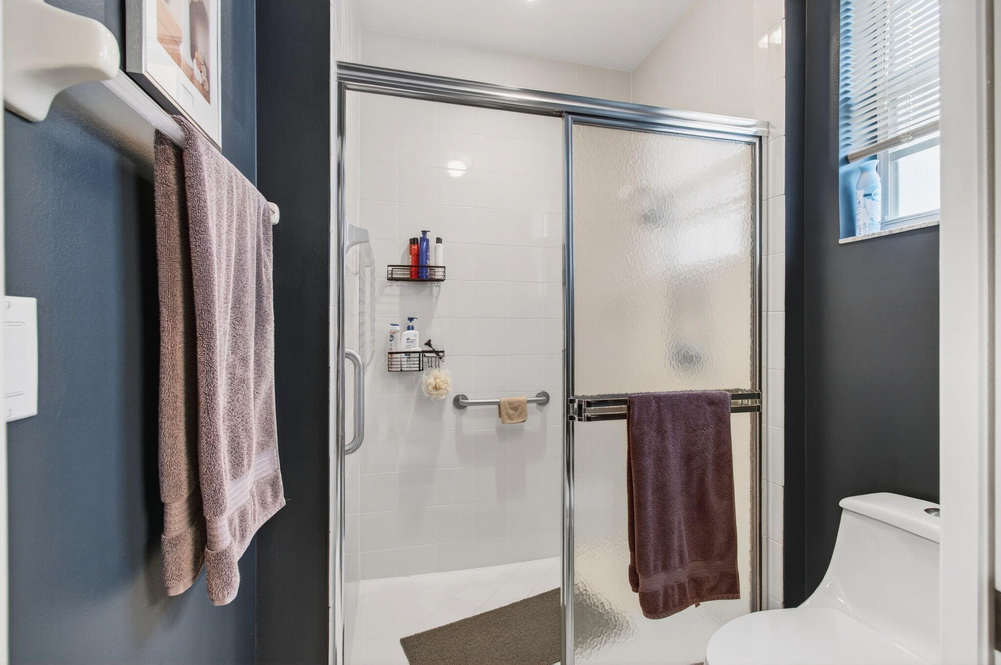 6253 Heliconia Road Delray Beach, FL 33484 - Photo 34 of 85 a bathroom with a shower and a glass door