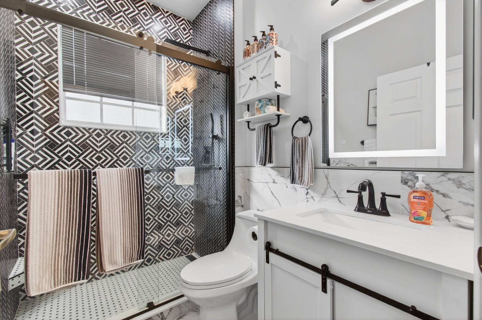 6253 Heliconia Road Delray Beach, FL 33484 - Photo 37 of 85 a bathroom with a sink a toilet and shower